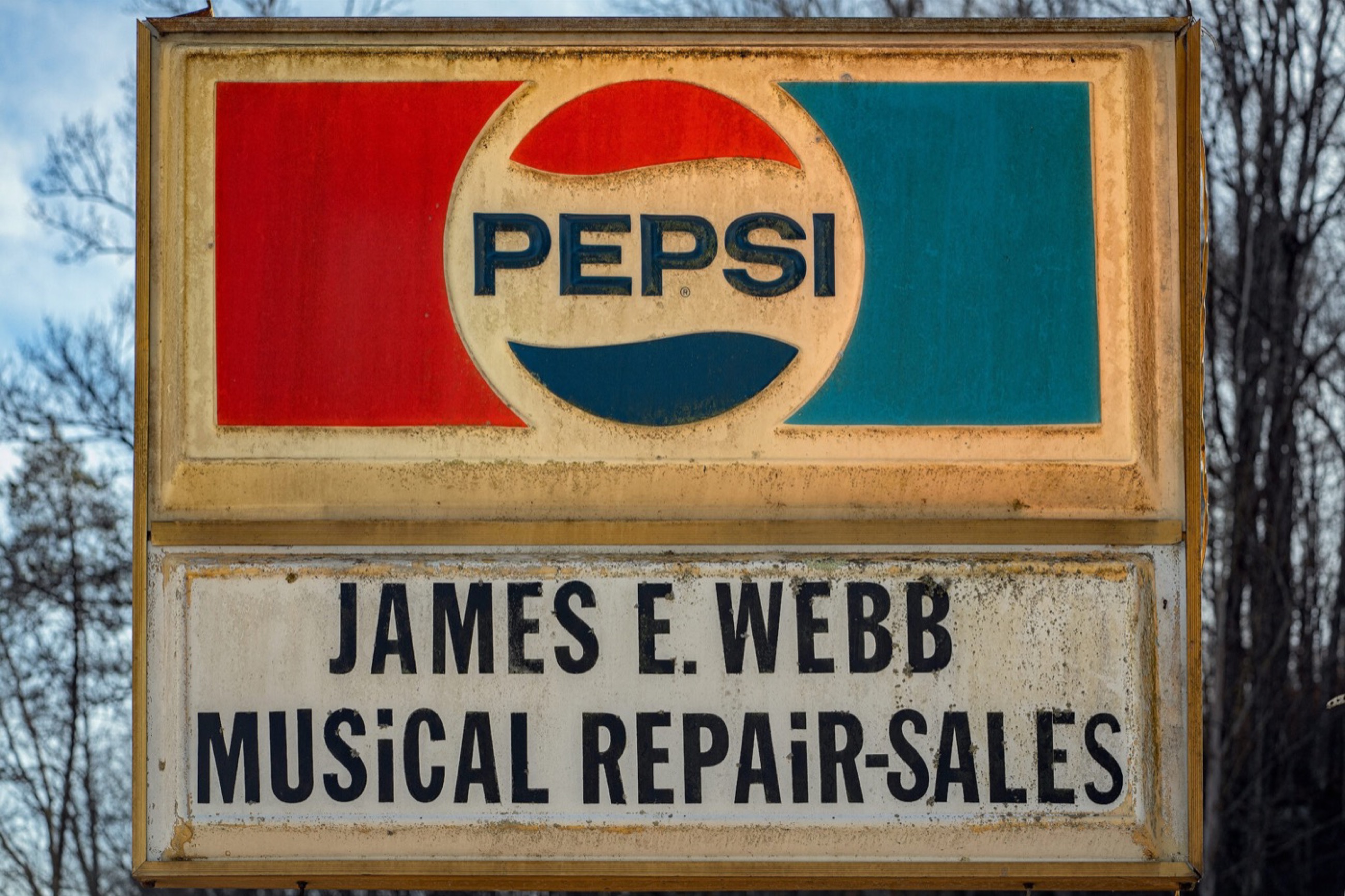 Roadside sign for Webb Music Shop in Tomahawk